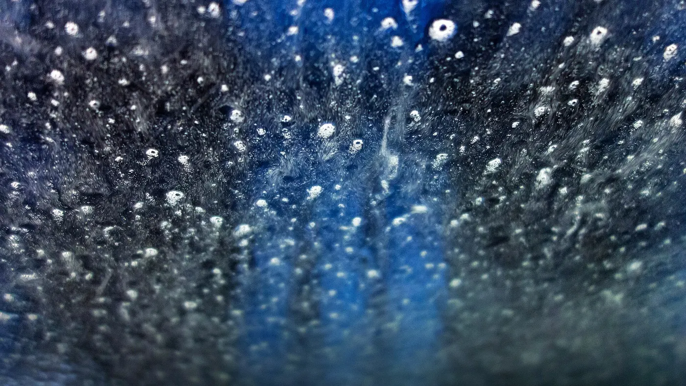 Water spraying across a car in a car wash