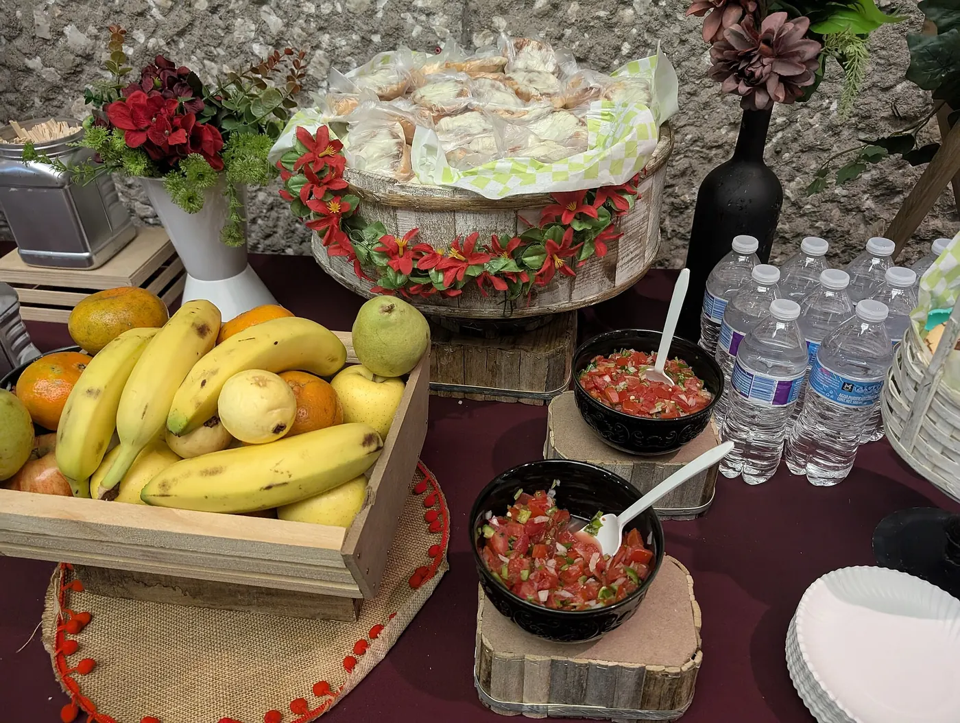 A catered buffet table with fruit and dishes