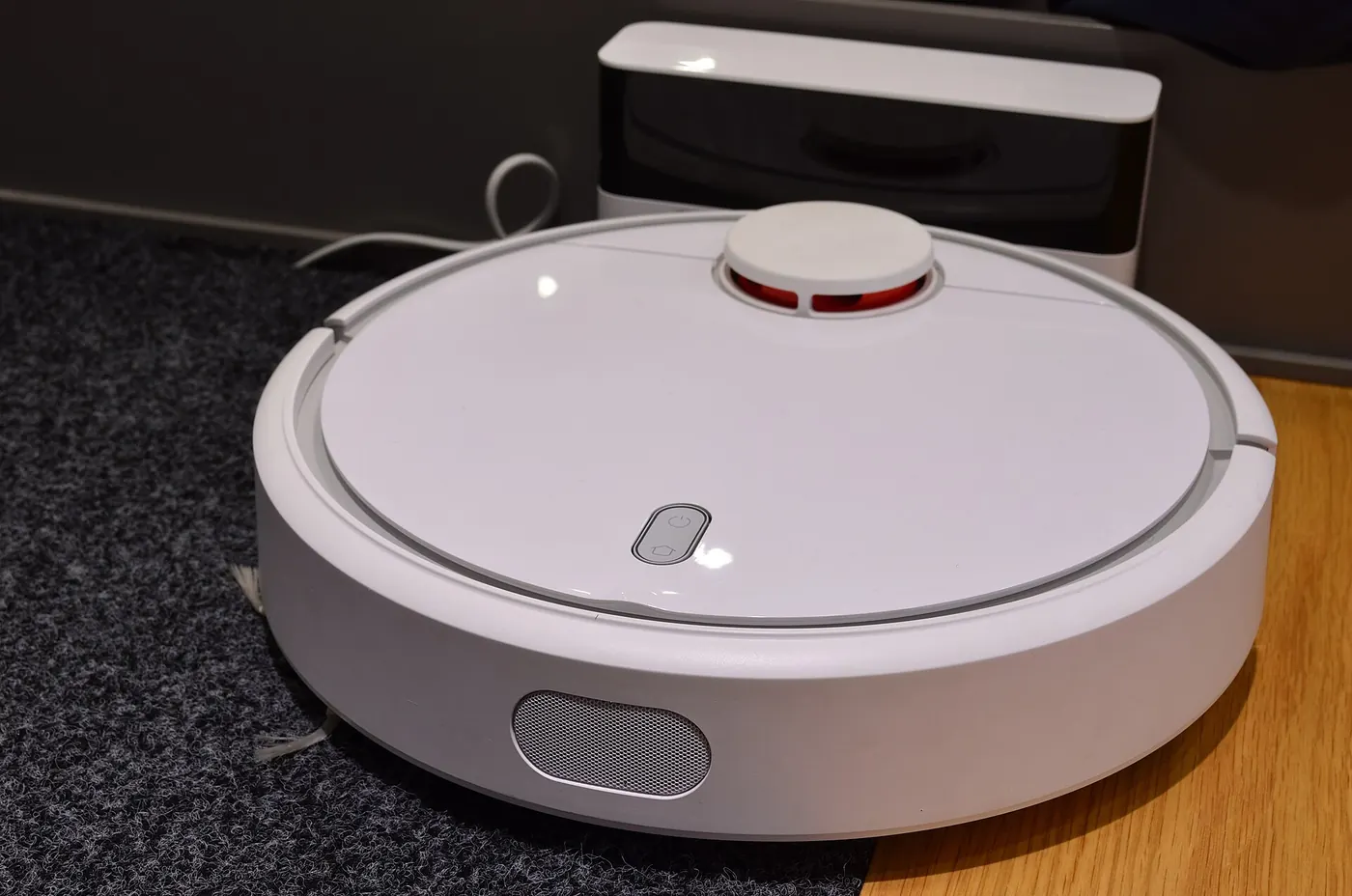 A robot vacuum on a wooden floor