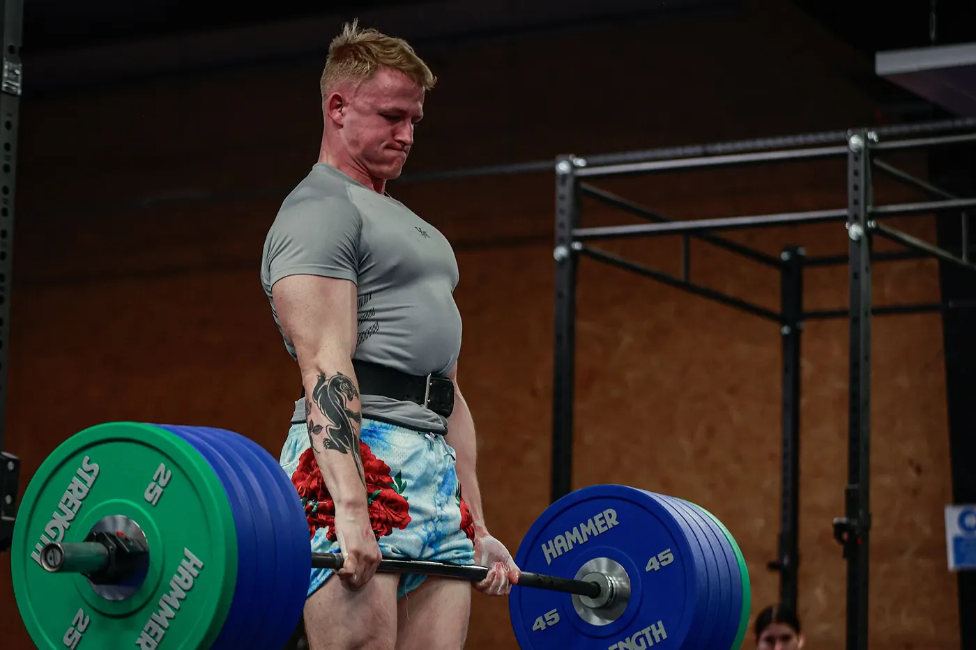 An athlete preparing to deadlift a loaded barbell