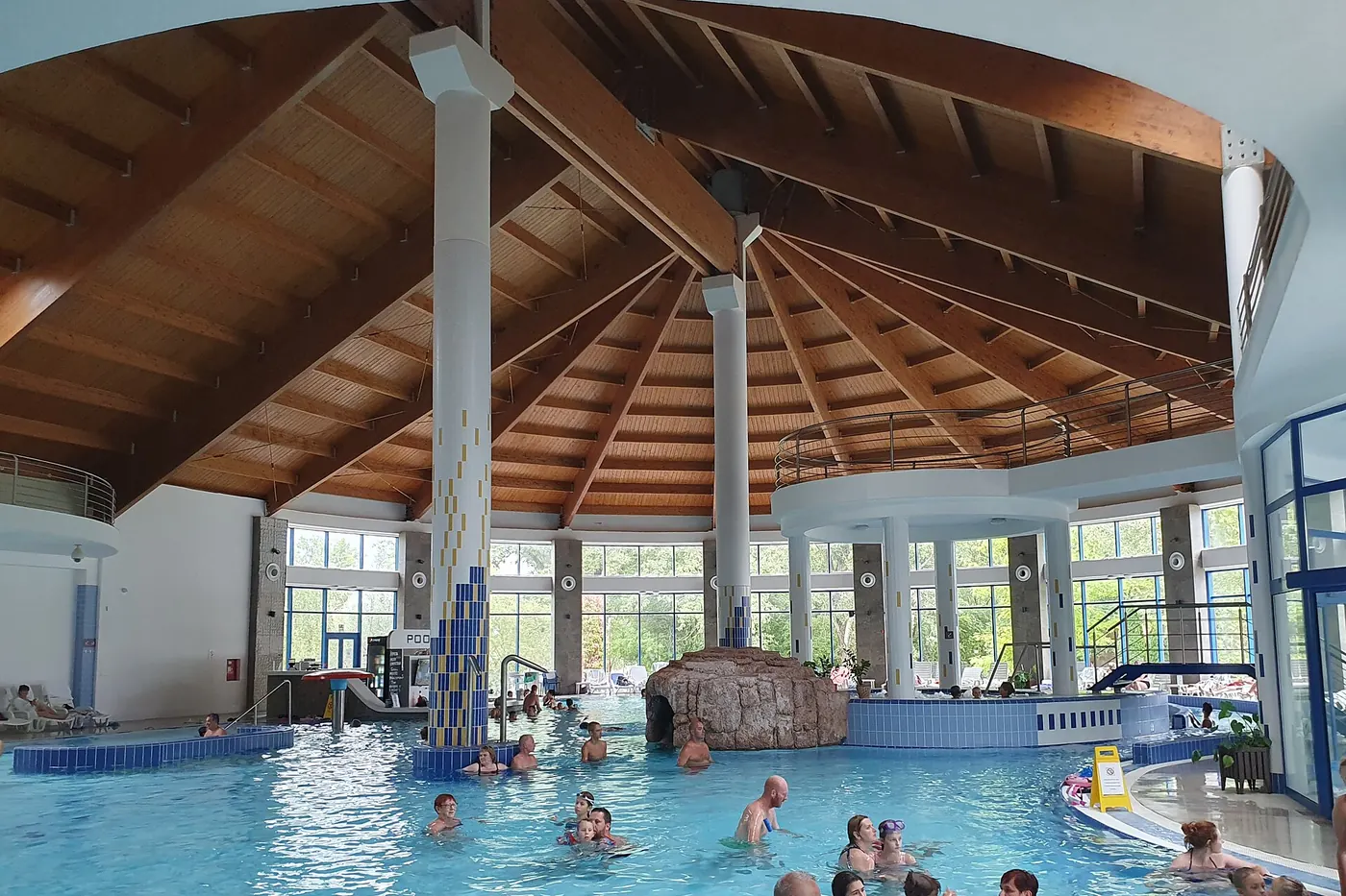 An indoor spa pool under a timber roof