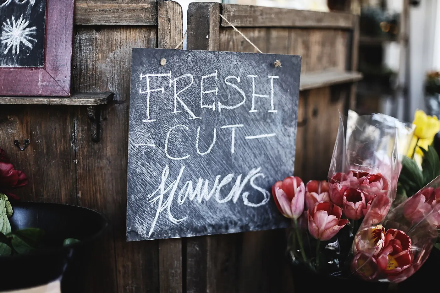A chalkboard sign reading fresh cut flowers