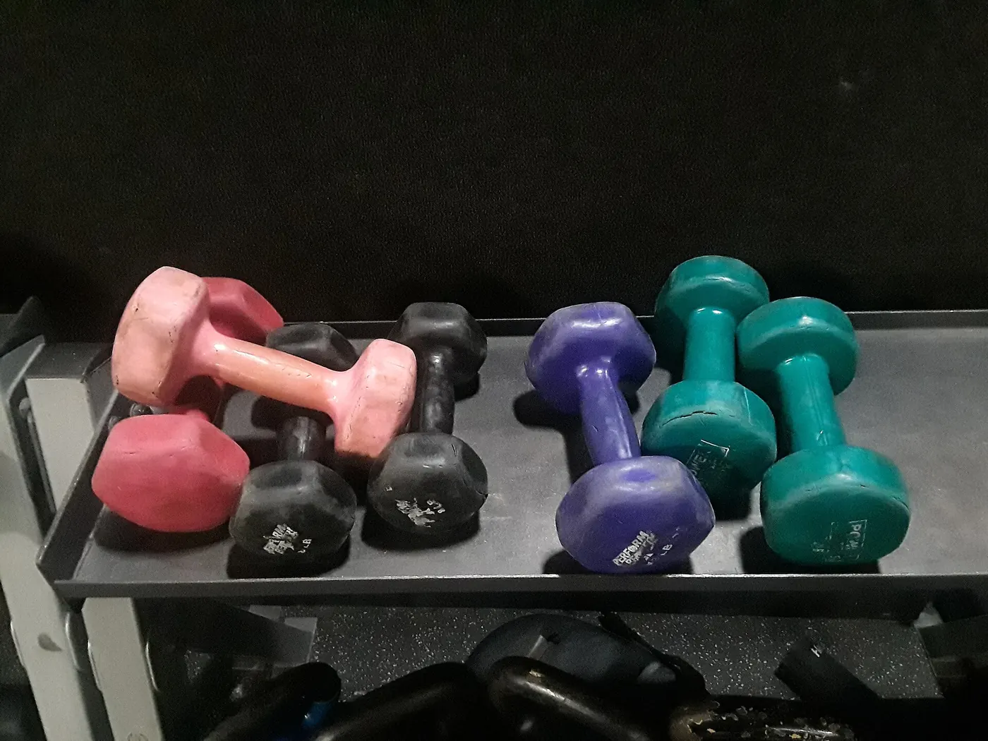 Colourful dumbbells on a rack