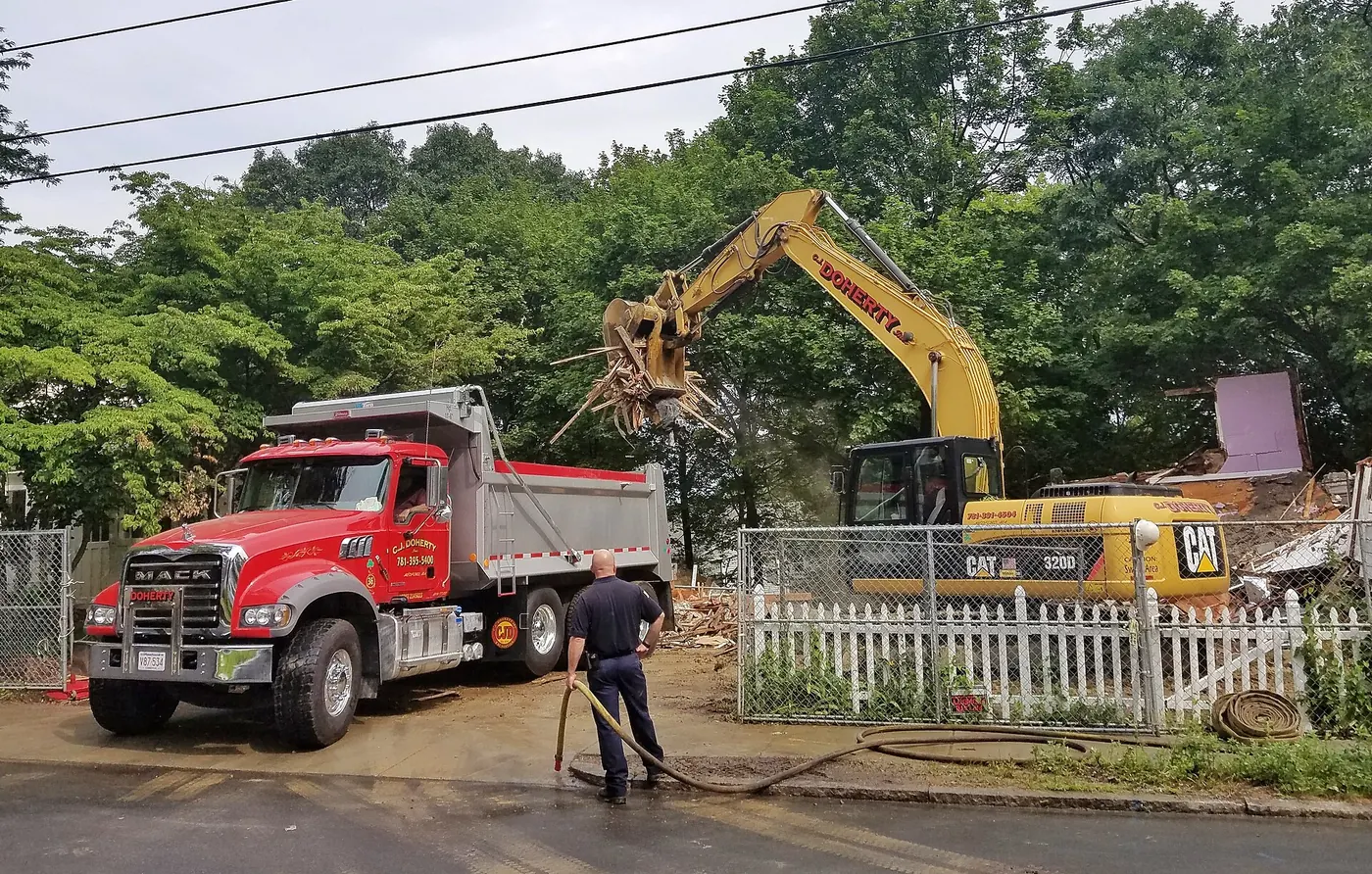 An excavator and truck on a house building site