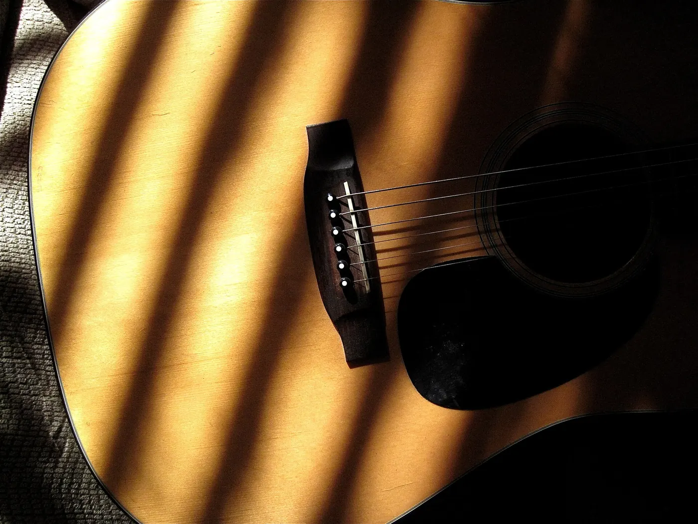 Sunlight across the body of an acoustic guitar