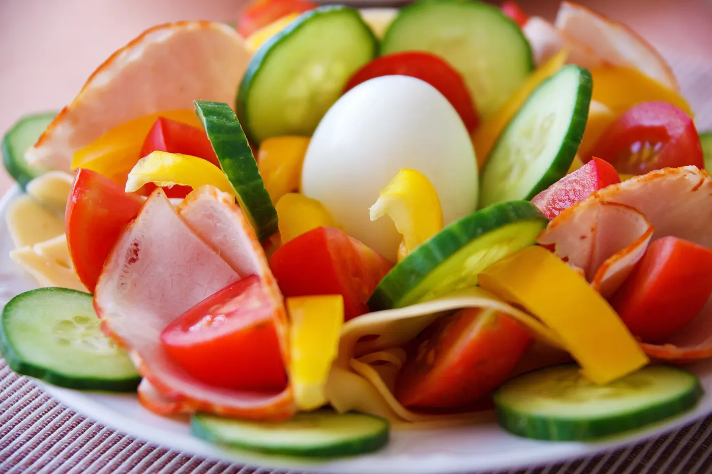 A fresh salad with egg, cucumber and tomatoes