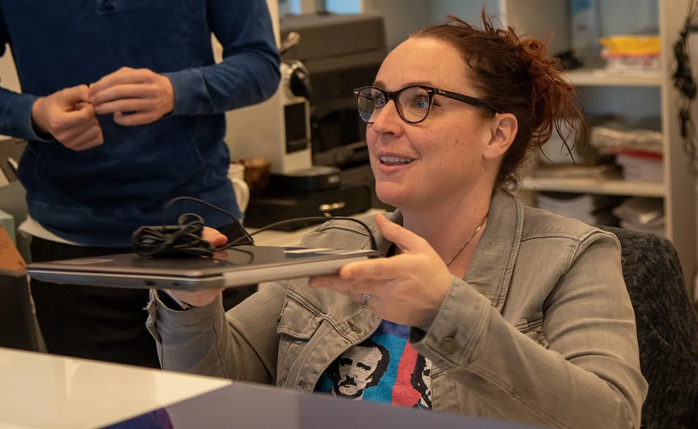A teacher presenting to a class with a laptop