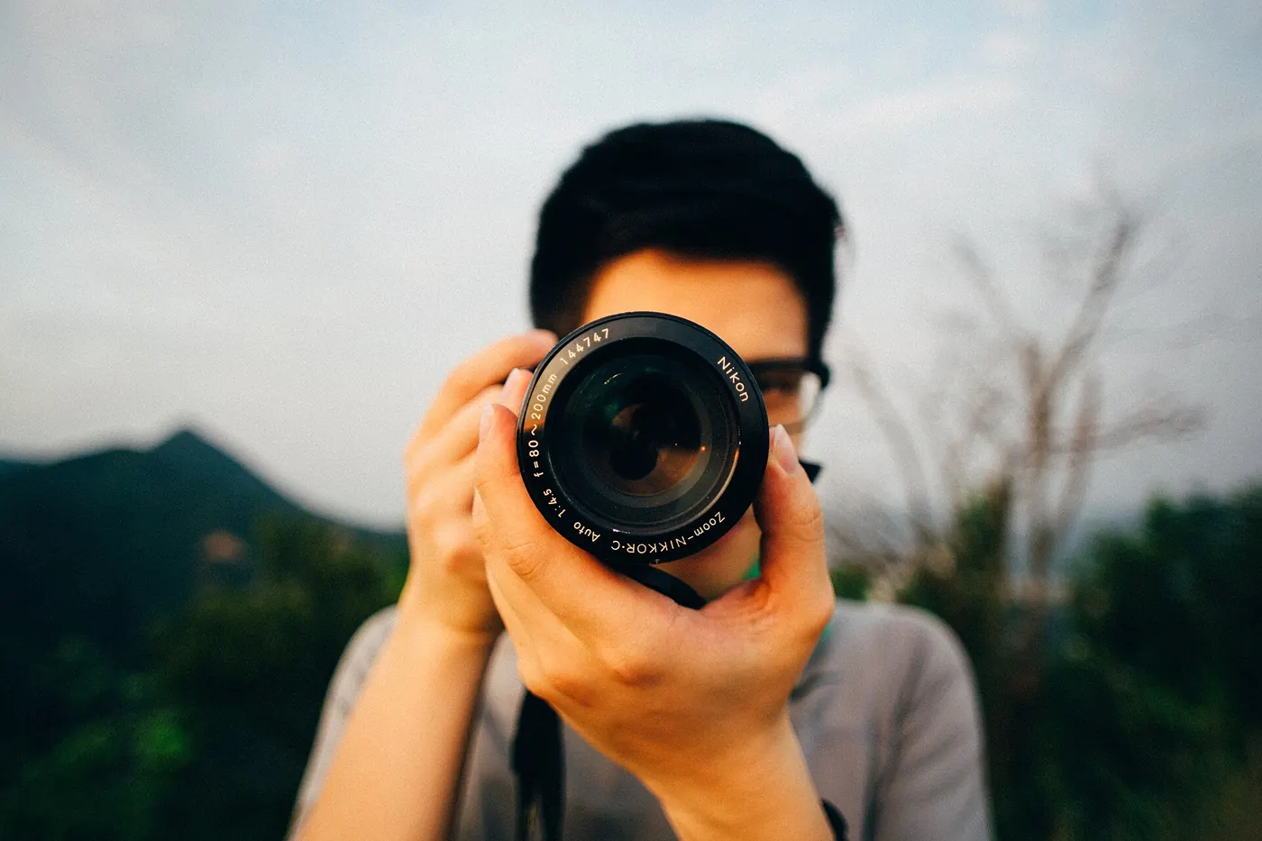 A photographer pointing a camera straight at the lens