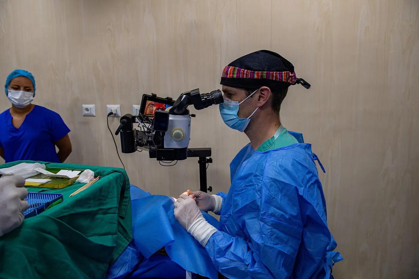 A surgeon operating with a surgical microscope