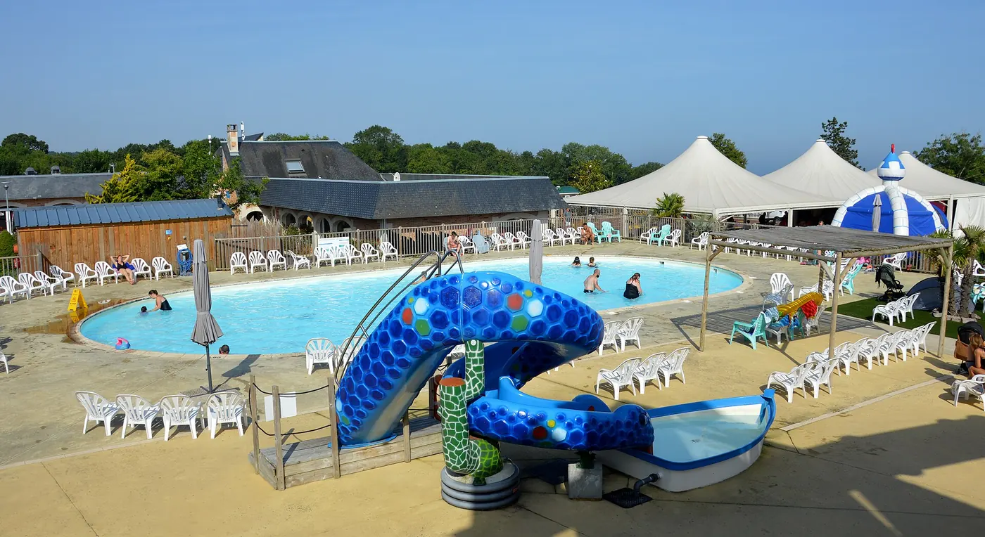 An outdoor swimming pool with a water slide