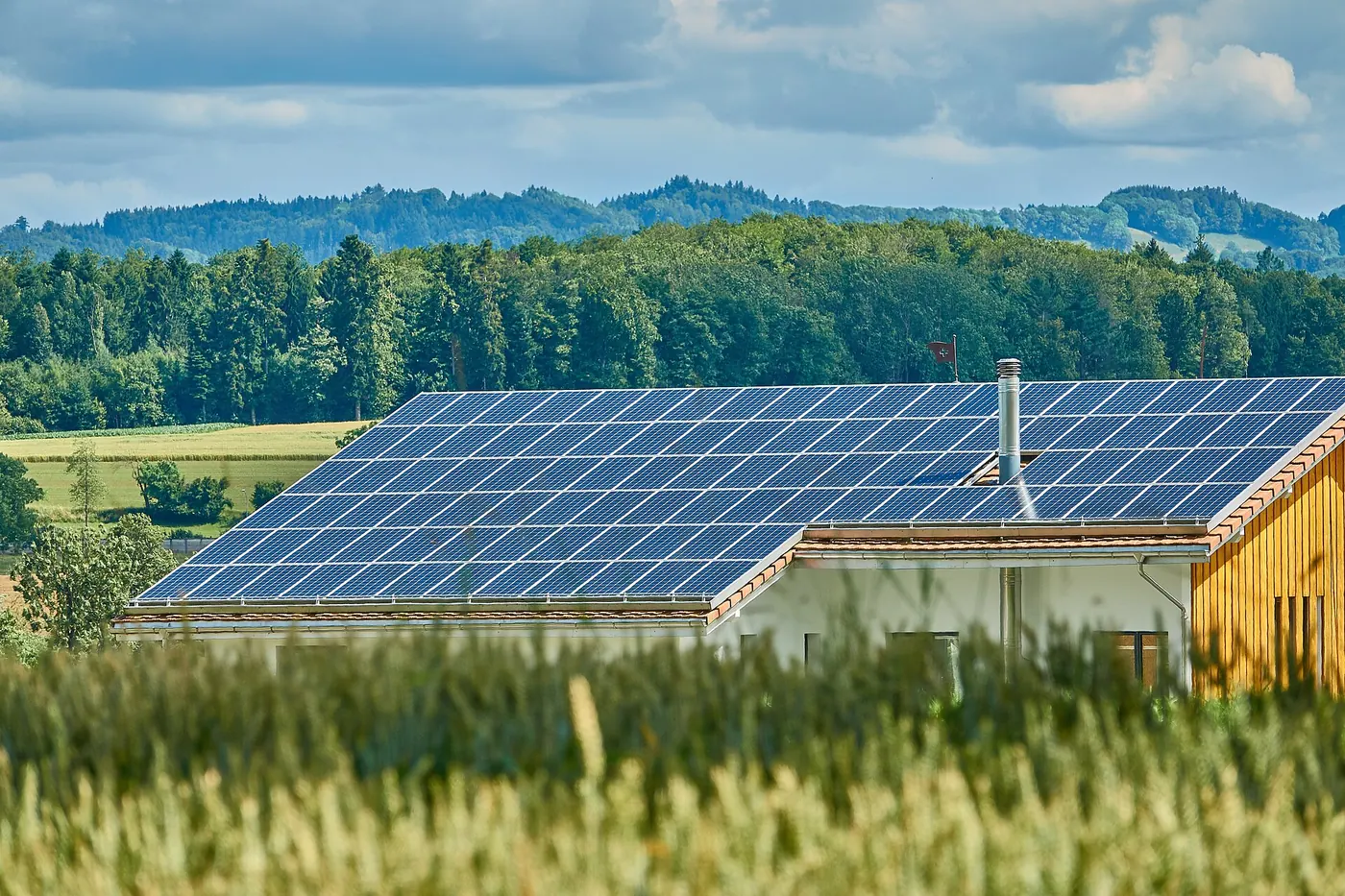 Solar panels on a roof overlooking green fields