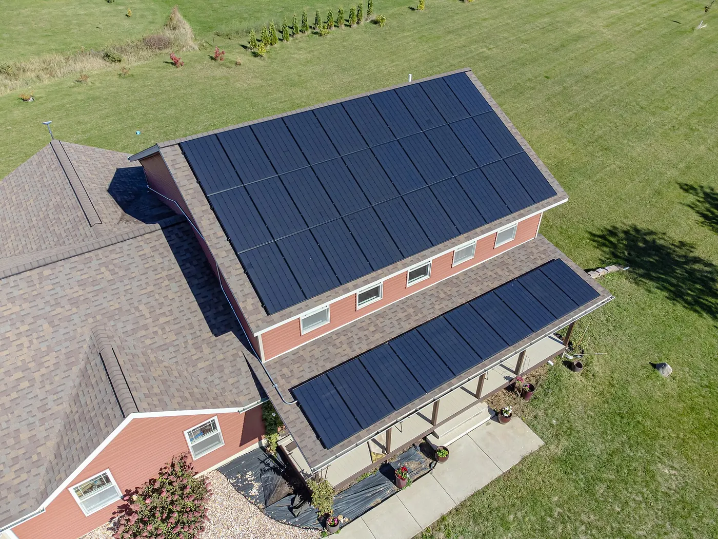 Solar panels covering the roof of a brick house