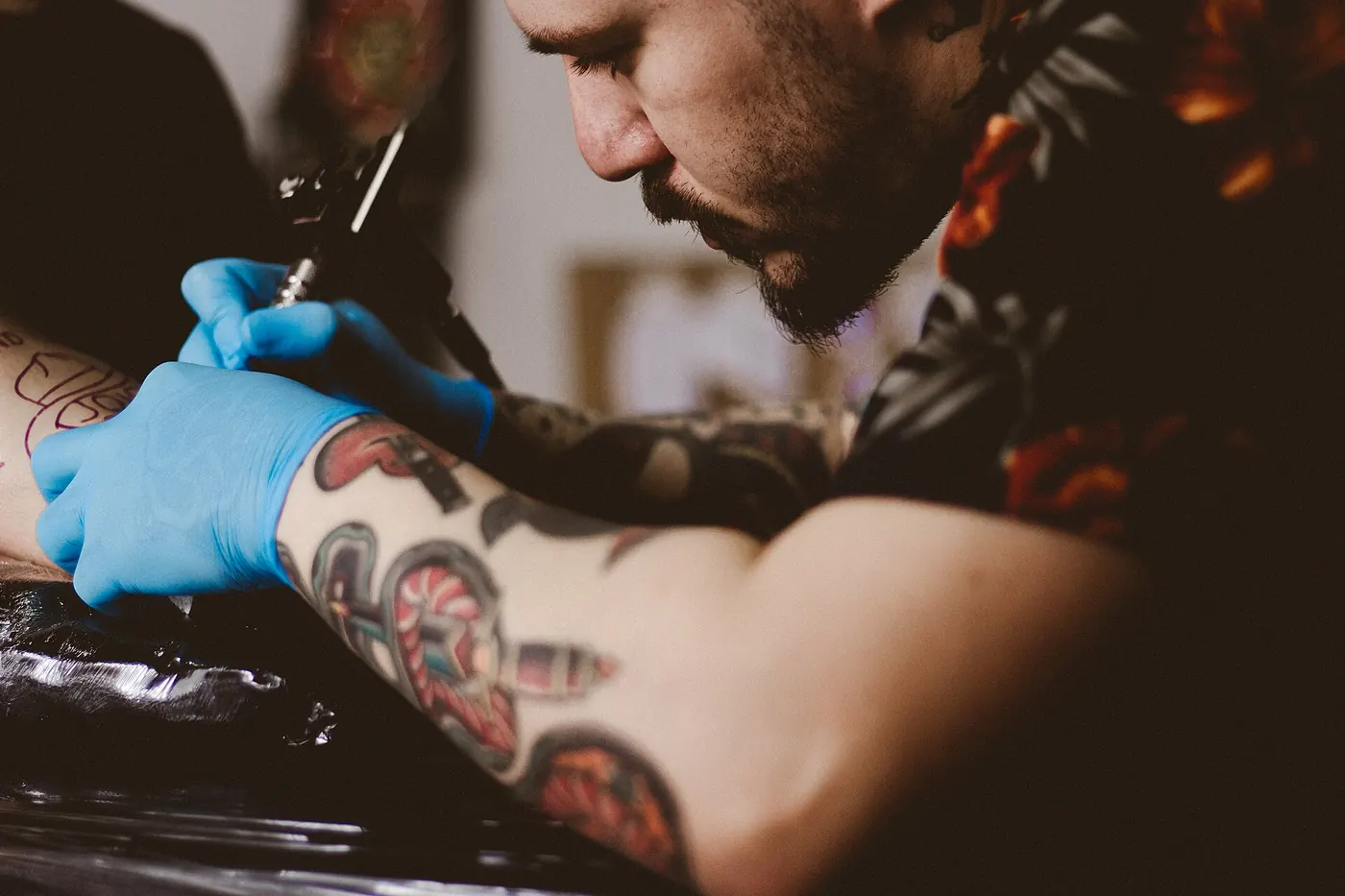 A tattoo in progress, artist in gloves