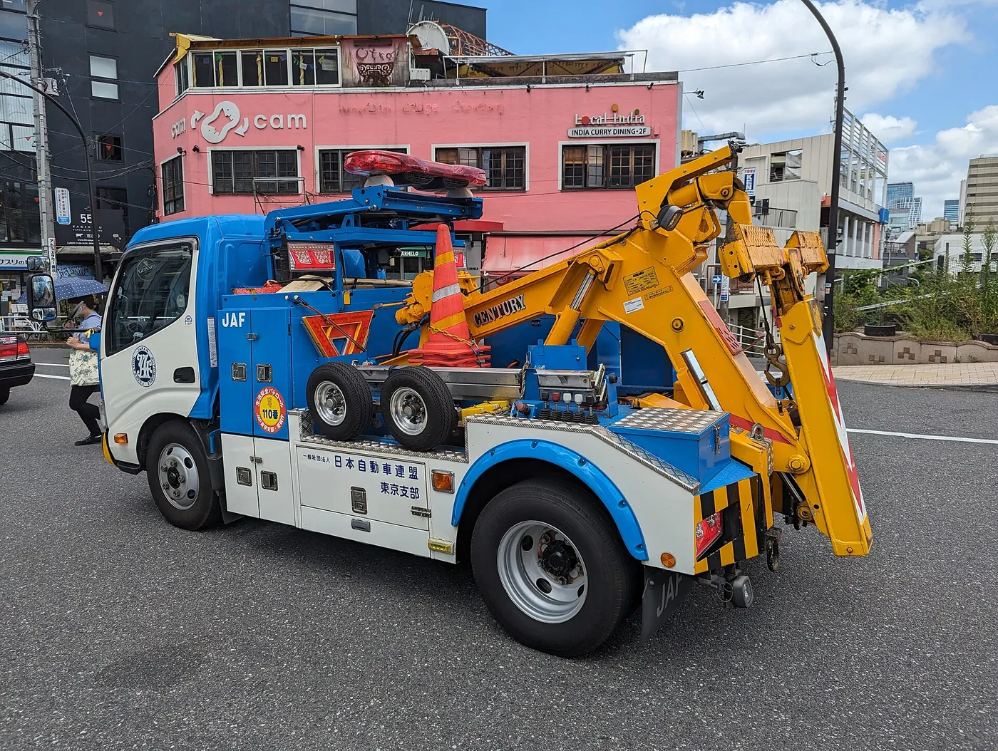 A tow truck parked on a city street