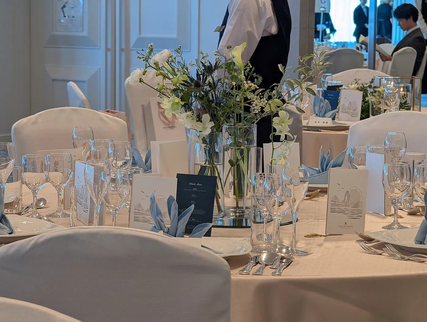 Wedding reception tables set with glassware and flowers